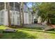 Inviting backyard features a grill, seating area, and cornhole boards on a well-maintained lawn at 40 Grand Pavilion Blvd, Isle of Palms, SC 29451