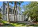 Beautiful backyard with lush trees, a grill, and cornhole, creating a perfect outdoor retreat at 40 Grand Pavilion Blvd, Isle of Palms, SC 29451