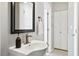 Bathroom with a white sink, elegant mirror, and classic black-and-white tiled floor at 40 Grand Pavilion Blvd, Isle of Palms, SC 29451