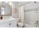 Bright bathroom with a white vanity, a shower-tub combo, and nautical-themed decor at 40 Grand Pavilion Blvd, Isle of Palms, SC 29451