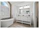 Elegant bathroom showcasing a soaking tub, double vanity, and modern fixtures at 40 Grand Pavilion Blvd, Isle of Palms, SC 29451
