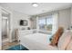 Comfortable bedroom with a white bed, TV, and window, designed for relaxation and entertainment at 40 Grand Pavilion Blvd, Isle of Palms, SC 29451