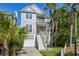 Attractive two-story home with a garage, front porch, and vibrant landscaping at 40 Grand Pavilion Blvd, Isle of Palms, SC 29451
