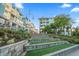 Exterior view of condos surrounded by mature trees and steps with green spaces at 40 Grand Pavilion Blvd, Isle of Palms, SC 29451
