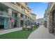 Outdoor area with seating, landscaping, and walkways between buildings with cafes at 40 Grand Pavilion Blvd, Isle of Palms, SC 29451