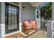 Cozy front porch with comfortable seating, a welcoming door, and charming decor at 40 Grand Pavilion Blvd, Isle of Palms, SC 29451