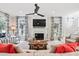 Bright living room with a fireplace, large windows, and stylish furnishings at 40 Grand Pavilion Blvd, Isle of Palms, SC 29451