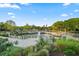Scenic pond with fountain surrounded by manicured landscaping and residential buildings at 40 Grand Pavilion Blvd, Isle of Palms, SC 29451