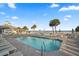 Community pool with lounge chairs, palm trees, and umbrellas for relaxation at 40 Grand Pavilion Blvd, Isle of Palms, SC 29451