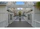 Covered walkway with retail stores on both sides with colorful buildings in the background at 40 Grand Pavilion Blvd, Isle of Palms, SC 29451