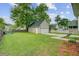 Large backyard with detached garage, lush green lawn, and wooden fence at 41 Regency Oaks Dr, Summerville, SC 29485
