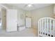 Bright bedroom with white furniture, a crib, and neutral walls at 41 Regency Oaks Dr, Summerville, SC 29485
