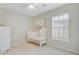 Cozy bedroom featuring a crib, window with plantation shutters, and neutral decor at 41 Regency Oaks Dr, Summerville, SC 29485