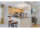 Well-lit kitchen with granite countertops, stainless steel appliances, and a breakfast bar with seating at 41 Regency Oaks Dr, Summerville, SC 29485