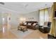 Bright living room features hardwood floors, a ceiling fan, and a comfortable leather sofa and chair at 41 Regency Oaks Dr, Summerville, SC 29485