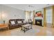 Comfortable living room with leather sofa, fireplace, and neutral decor, perfect for relaxing and entertaining at 41 Regency Oaks Dr, Summerville, SC 29485