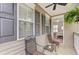 Inviting porch with seating area, ceiling fan, and view into the Primary bedroom at 41 Regency Oaks Dr, Summerville, SC 29485