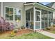 Charming screened porch with outdoor seating and manicured yard at 41 Regency Oaks Dr, Summerville, SC 29485