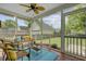 Relaxing screened porch with outdoor seating and view of the fenced backyard and detached garage at 41 Regency Oaks Dr, Summerville, SC 29485