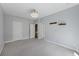 Spacious bedroom with neutral carpet, light gray walls, and doors leading to other rooms at 4926 Lake Palmetto Ln, North Charleston, SC 29418