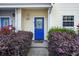 Charming home exterior featuring a bright blue front door and well-manicured landscaping at 4926 Lake Palmetto Ln, North Charleston, SC 29418