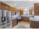 Well-lit kitchen featuring stainless steel appliances, granite counters, and wooden cabinetry at 4926 Lake Palmetto Ln, North Charleston, SC 29418