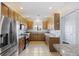 Bright kitchen features stainless steel appliances, granite countertops, and classic wooden cabinets at 4926 Lake Palmetto Ln, North Charleston, SC 29418