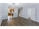 Bright living room featuring hardwood floors, elegant lighting, and open access to kitchen at 4926 Lake Palmetto Ln, North Charleston, SC 29418