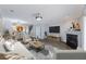 Inviting living room with open floor plan, fireplace, large screen TV, and modern furniture at 4926 Lake Palmetto Ln, North Charleston, SC 29418