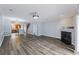 Open-concept living area featuring hardwood floors, fireplace, and access to a kitchen at 4926 Lake Palmetto Ln, North Charleston, SC 29418