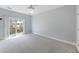 Spacious main bedroom with carpet floors and a balcony with sliding glass doors at 4926 Lake Palmetto Ln, North Charleston, SC 29418