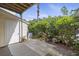 Small, shaded patio with access to a storage closet and lush landscaping at 4926 Lake Palmetto Ln, North Charleston, SC 29418
