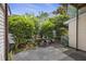 Cozy patio area surrounded by lush greenery, flowers, and potted plants at 4926 Lake Palmetto Ln, North Charleston, SC 29418