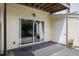 Small patio area with sliding glass door, storage closet, and drought-tolerant landscaping at 4926 Lake Palmetto Ln, North Charleston, SC 29418