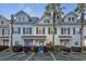 Charming townhomes with colorful doors, manicured landscaping and palm trees, offering a welcoming curb appeal at 4926 Lake Palmetto Ln, North Charleston, SC 29418