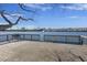 A waterfront deck with a bench offers serene views of the water and a glimpse of the community at 4926 Lake Palmetto Ln, North Charleston, SC 29418