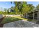 Expansive backyard featuring a screened porch, mature trees, and well-maintained lawn, perfect for outdoor enjoyment at 540 Castle Hall Rd, Mount Pleasant, SC 29464