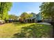 Large backyard with lush green lawn and a charming screened porch, perfect for outdoor activities and relaxation at 540 Castle Hall Rd, Mount Pleasant, SC 29464
