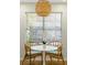Cozy breakfast nook with a round table, woven pendant lighting, and bright natural light at 540 Castle Hall Rd, Mount Pleasant, SC 29464