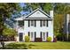 Charming two-story home with a light blue exterior, black shutters, and a cozy front porch at 540 Castle Hall Rd, Mount Pleasant, SC 29464
