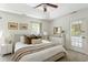 Well-lit main bedroom with a tray ceiling, plush bedding, and ensuite bathroom access at 540 Castle Hall Rd, Mount Pleasant, SC 29464