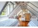Unique attic bedroom with vaulted ceilings, exposed beams, hardwood floors, and cozy seating area at 55 Laurens St # 55-A, Charleston, SC 29401