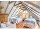 Unique attic bedroom features exposed beams, slanted ceilings, and two cozy twin beds with comfortable bedding at 55 Laurens St # 55-A, Charleston, SC 29401