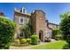 Charming brick home featuring lush landscaping, an inviting arched entryway, and a private outdoor patio area at 55 Laurens St # 55-A, Charleston, SC 29401