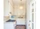 Well-lit kitchen with stainless steel refrigerator, gas cooktop and stone countertops at 55 Laurens St # 55-A, Charleston, SC 29401