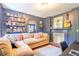 Cozy living room with a comfortable couch, built-in bookshelves, and a decorative fireplace with a guitar at 55 Laurens St # 55-A, Charleston, SC 29401