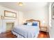 Cozy main bedroom with hardwood floors, fireplace, and ample natural light at 55 Laurens St # 55-A, Charleston, SC 29401