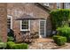 Brick patio featuring outdoor dining with lush green landscaping and a brick facade at 55 Laurens St # 55-A, Charleston, SC 29401