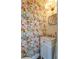 Charming powder room features vibrant wallpaper, white vanity, and a gold framed mirror at 55 Laurens St # 55-A, Charleston, SC 29401