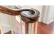 Close up of dark wood banister, decorative wood work and white staircase at 55 Laurens St # 55-A, Charleston, SC 29401